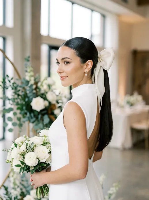 Sleek high ponytail with bow